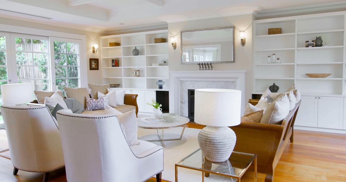 Light-filled apartment living room with built-in shelving