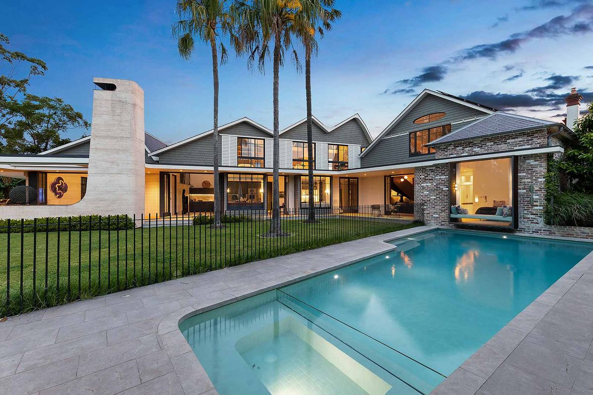 Pool terrace of a contemporary North Shore home at dusk