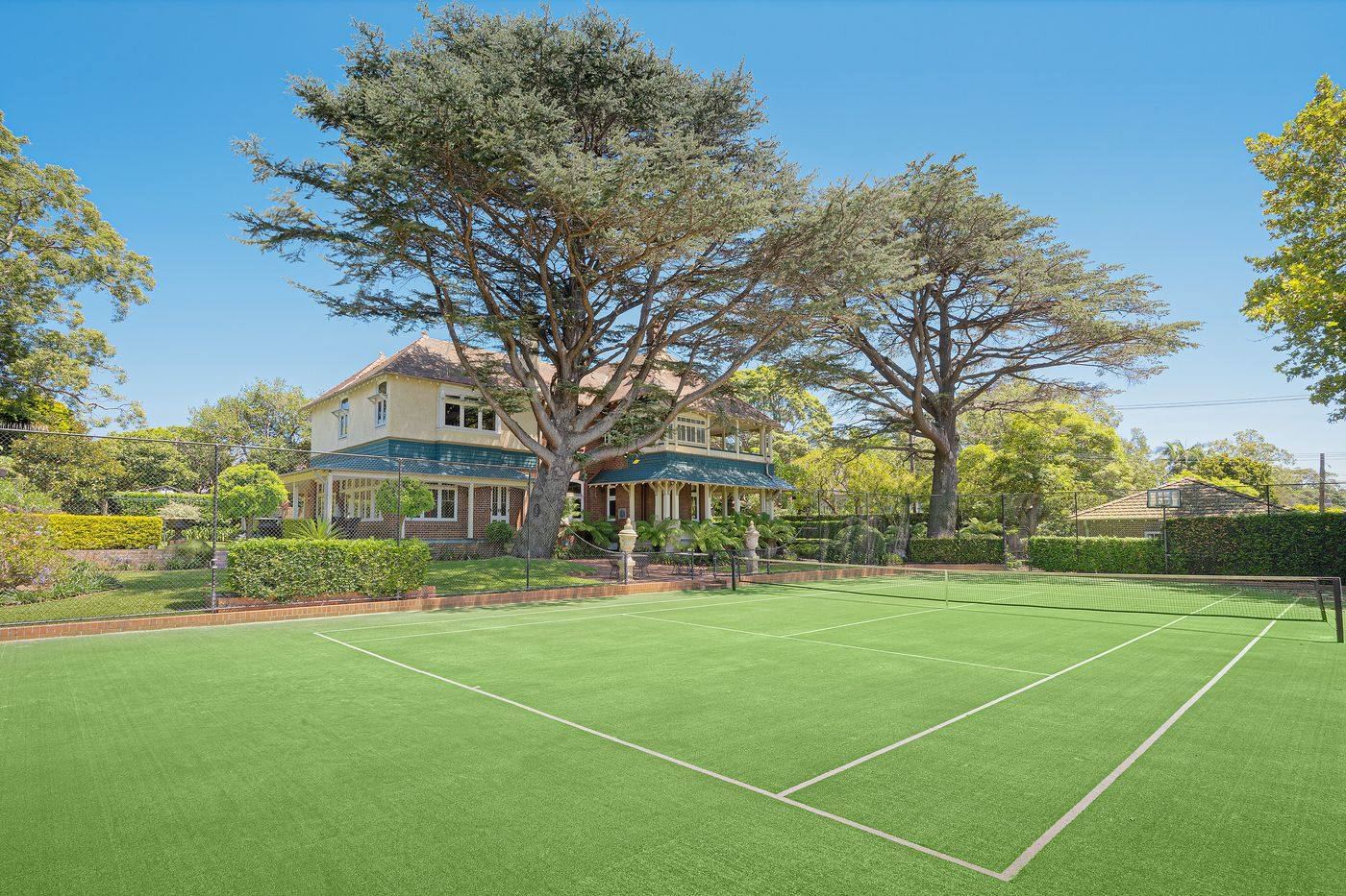 Private tennis court with the house beyond