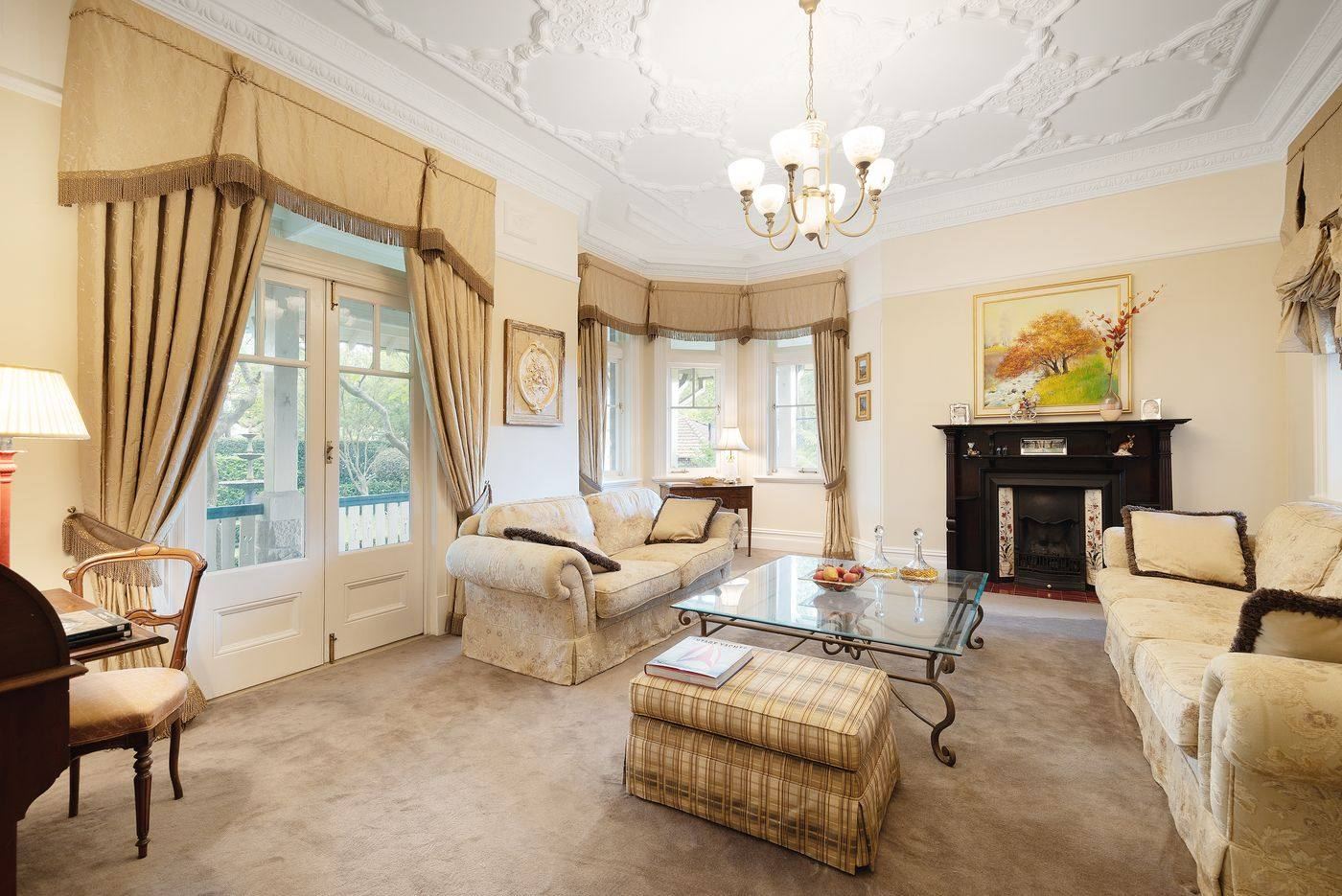 Formal lounge with ornamental ceiling and fireplace