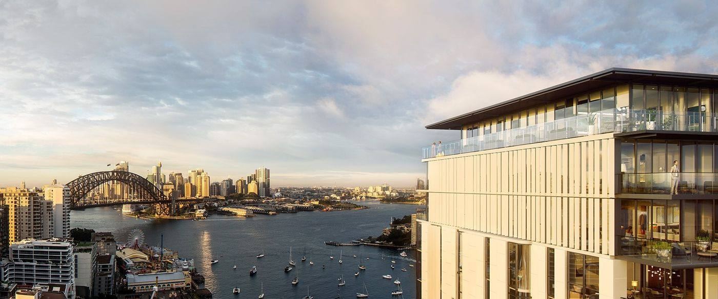 BLUE building beside Lavender Bay at sunset